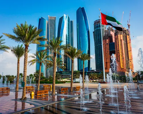 Abu Dhabi skyline with Etihad Towers and fountains - luxury chauffeur service by Prime Ride